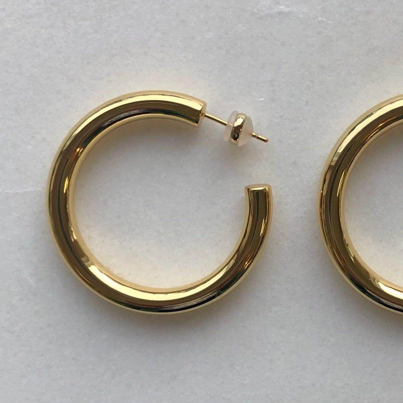 high polished 18K gold plated brass statement large hoops in that are light and hollow – minimalist trendy jewelry made in Vermont, perfect for casual wear, date night, work, weddings, gifting, or everyday wear.
