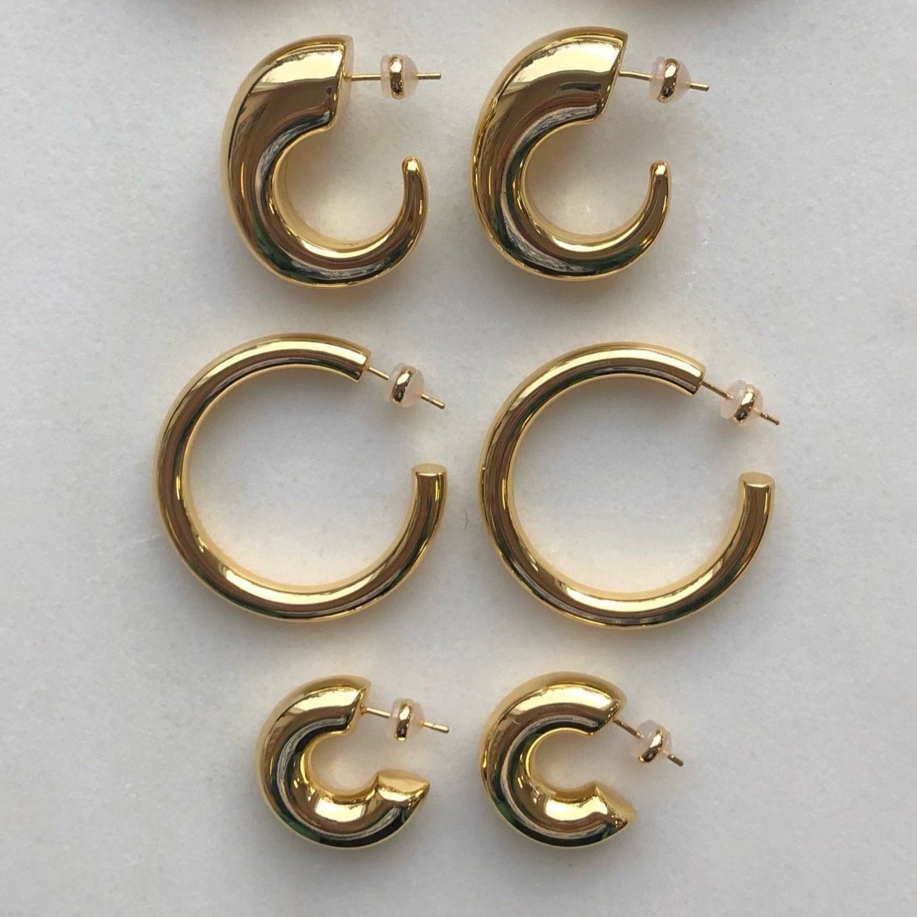 high polished 18K gold plated brass statement chunky bubble hoops in that are light and hollow – minimalist trendy jewelry made in Vermont, perfect for casual wear, date night, work, weddings, gifting, or everyday wear.